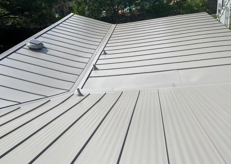 Solar attic fan installed on a metal roof for Roof Ventilation in Battle Ground